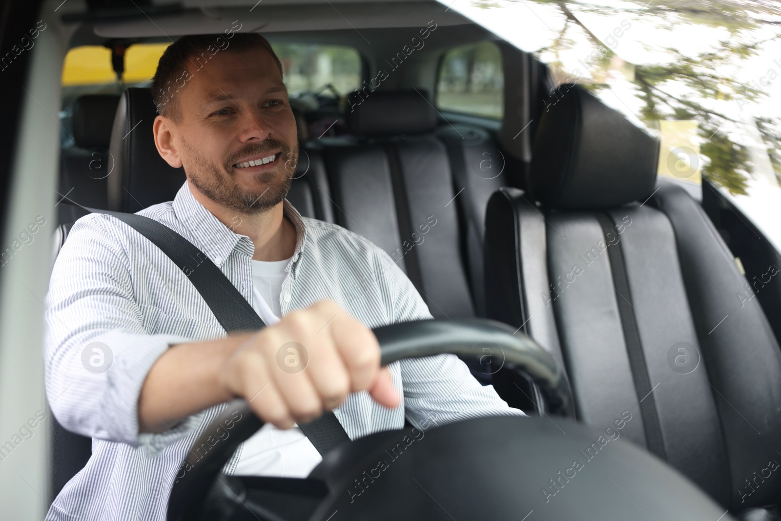 Photo of Man driving modern car, view through window