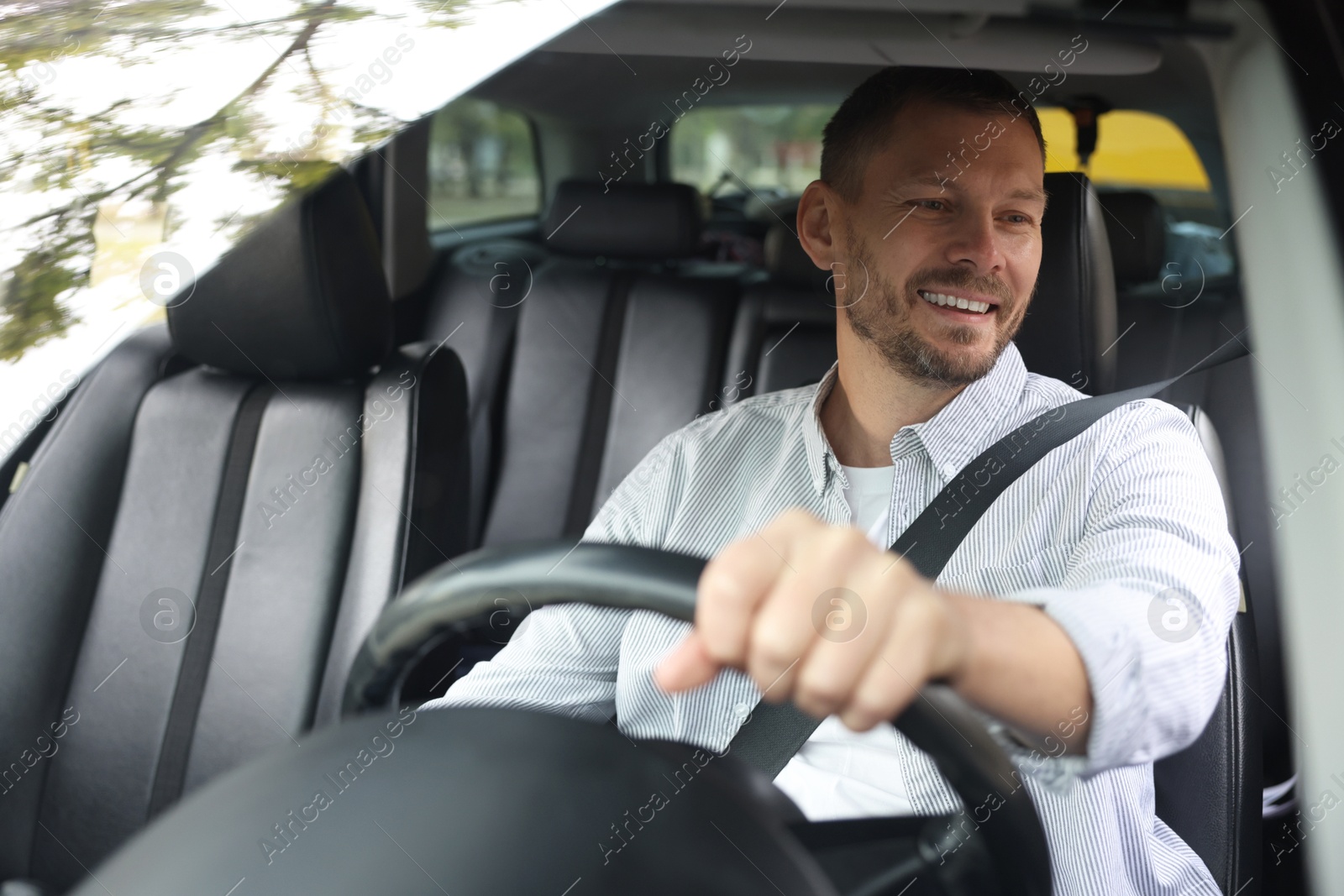 Photo of Man driving modern car, view through window