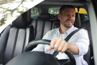 Man driving modern car, view through window