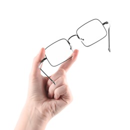 Photo of Woman holding glasses with black metal frame on white background, closeup