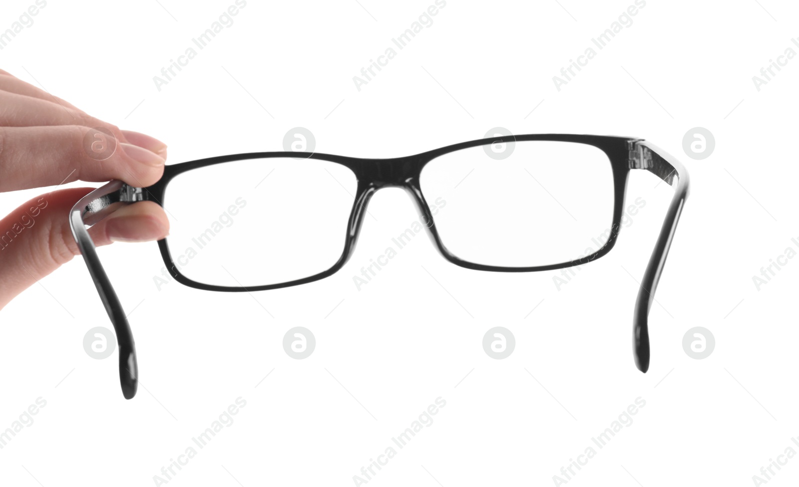 Photo of Woman holding glasses with black plastic frame on white background, closeup