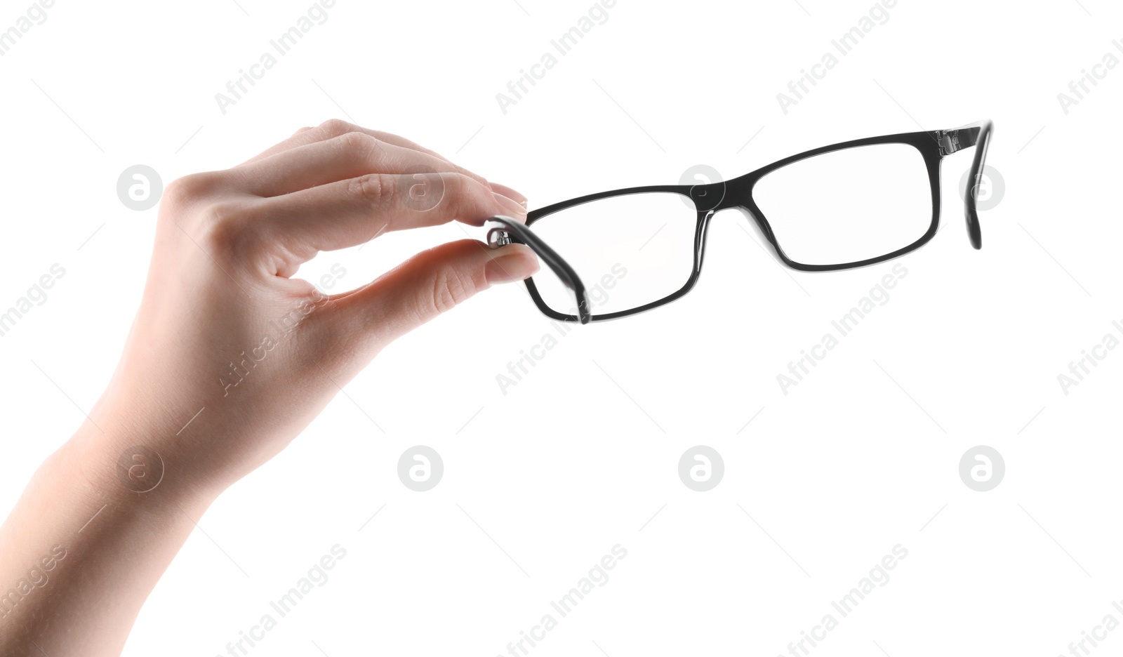 Photo of Woman holding glasses with black plastic frame on white background, closeup