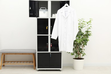 Photo of Medical personnel uniform on locker in changing room