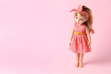 Photo of Beautiful doll in dress and headband on pink background. Space for text