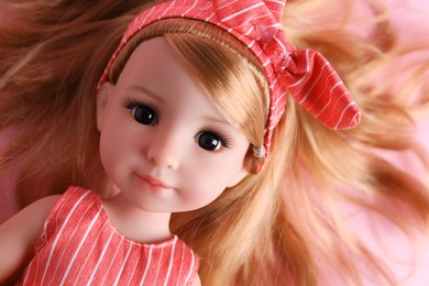 Photo of Beautiful doll with headband, closeup. Child's toy