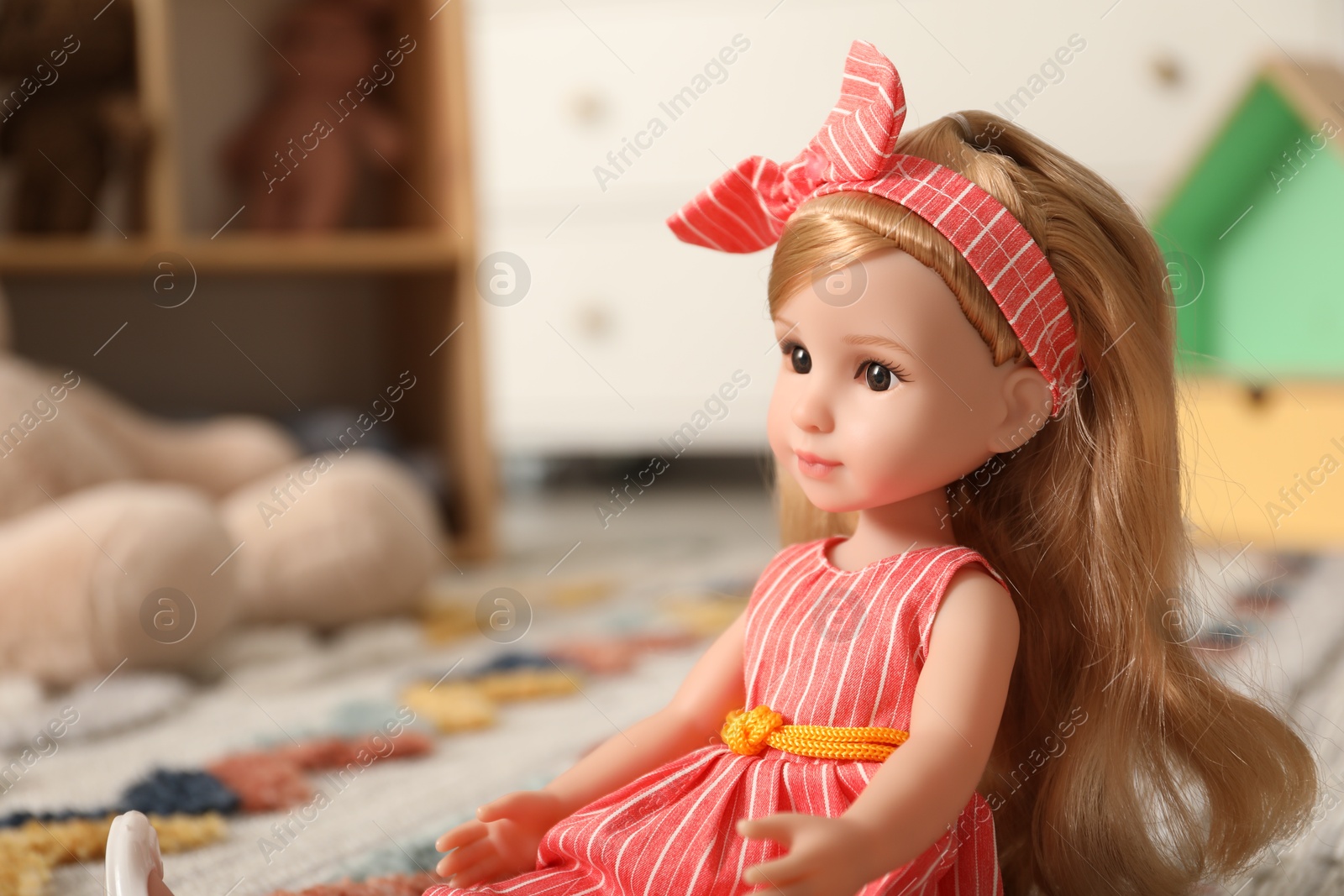 Photo of Beautiful doll in dress and headband indoors, closeup. Space for text