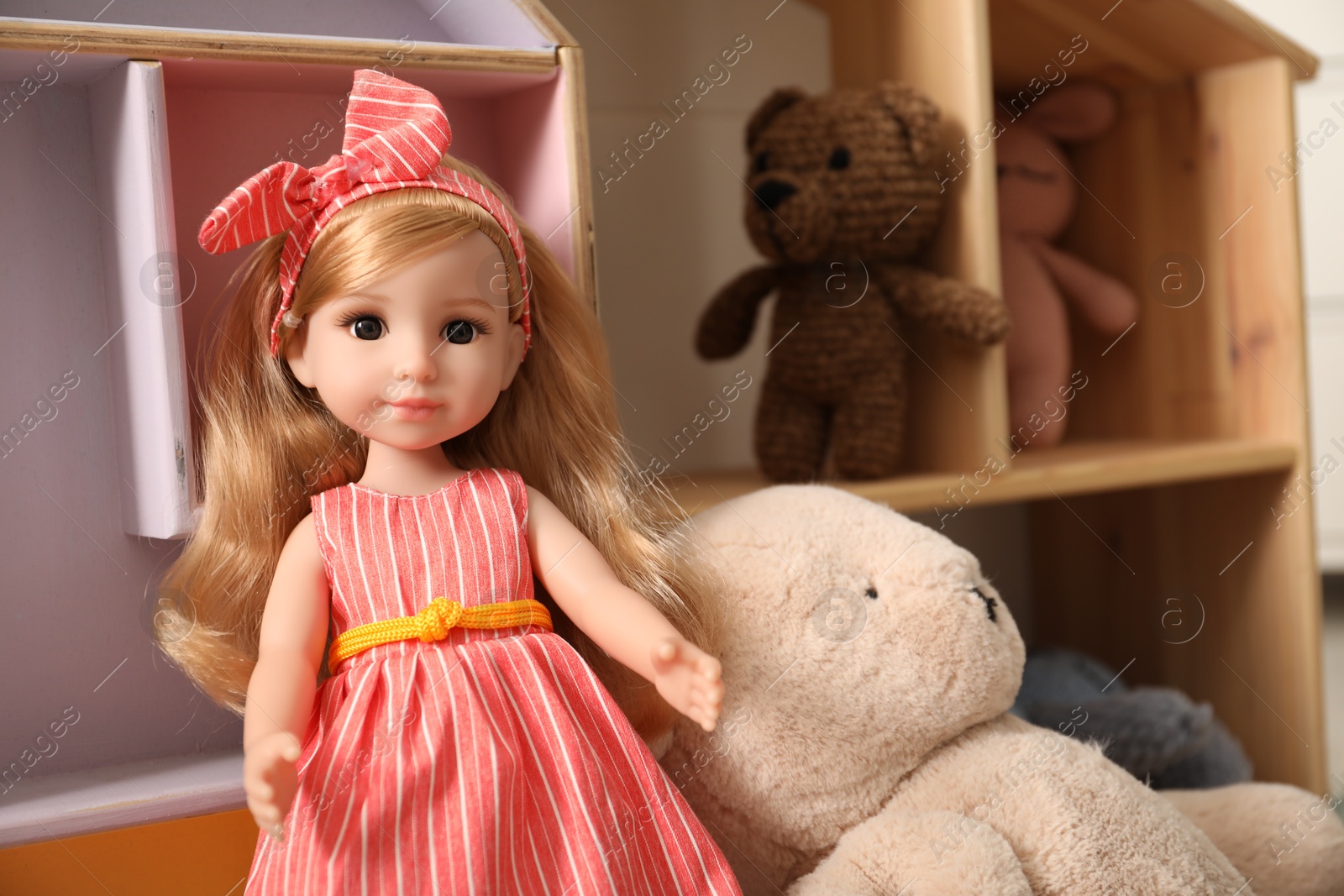 Photo of Beautiful doll and other toys indoors, closeup