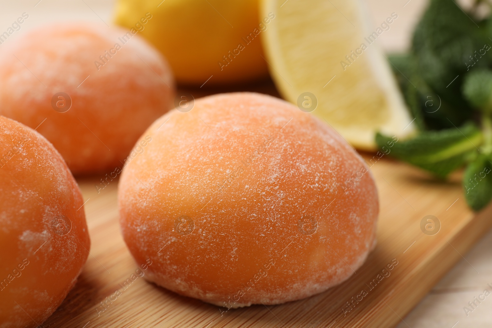 Photo of Delicious mochi on wooden table, closeup view