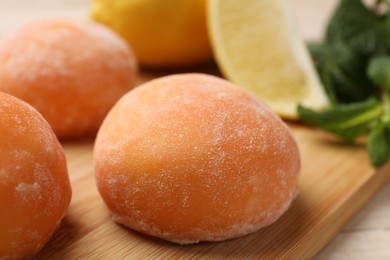 Photo of Delicious mochi on wooden table, closeup view