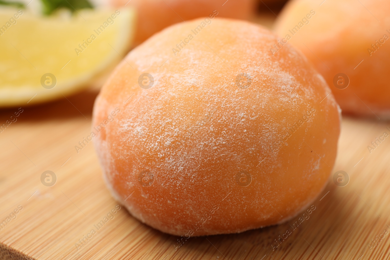 Photo of Delicious mochi on wooden table, closeup view