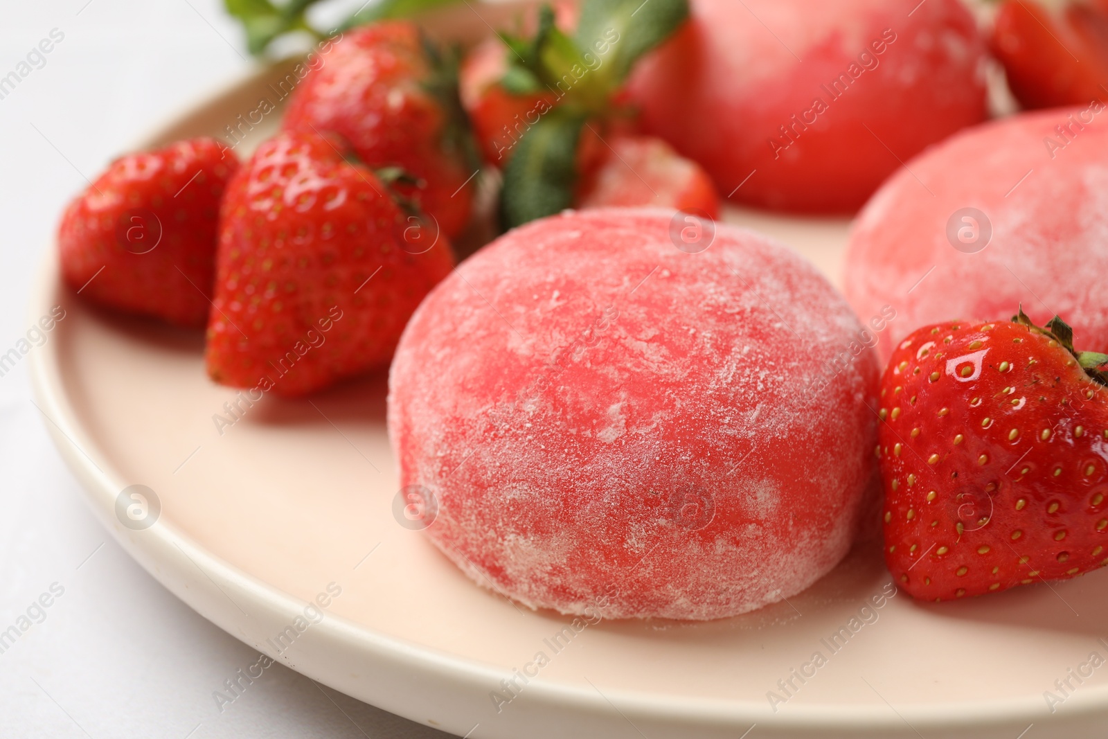 Photo of Delicious mochi, strawberries and mint on light table, closeup