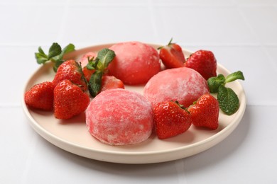 Photo of Delicious mochi, strawberries and mint on white table, closeup