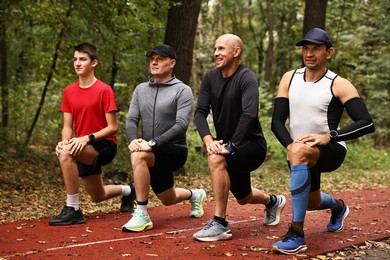 Photo of Group of people stretching in park. Healthy lifestyle