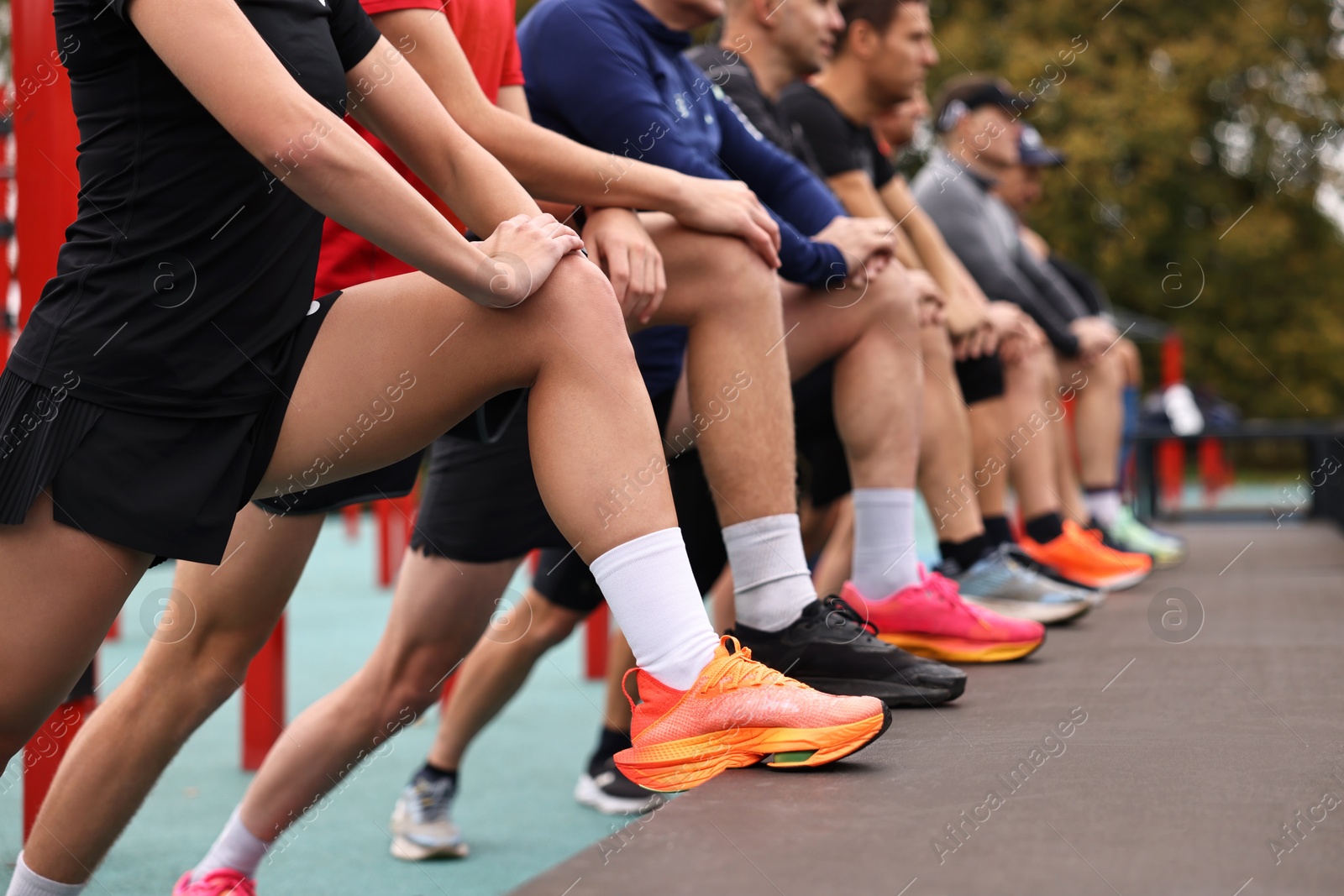 Photo of Group of people stretching in park, closeup