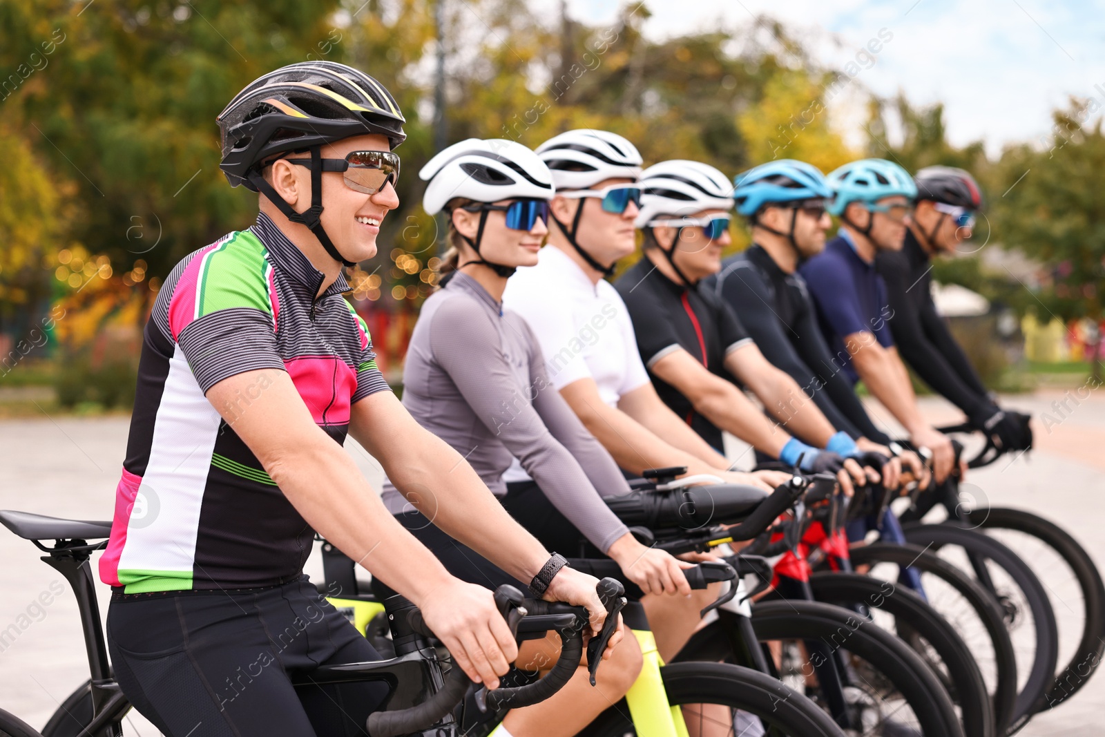 Photo of Group of athletic people with bicycles outdoors