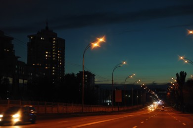 Photo of Cityscape with road traffic and street lights in evening