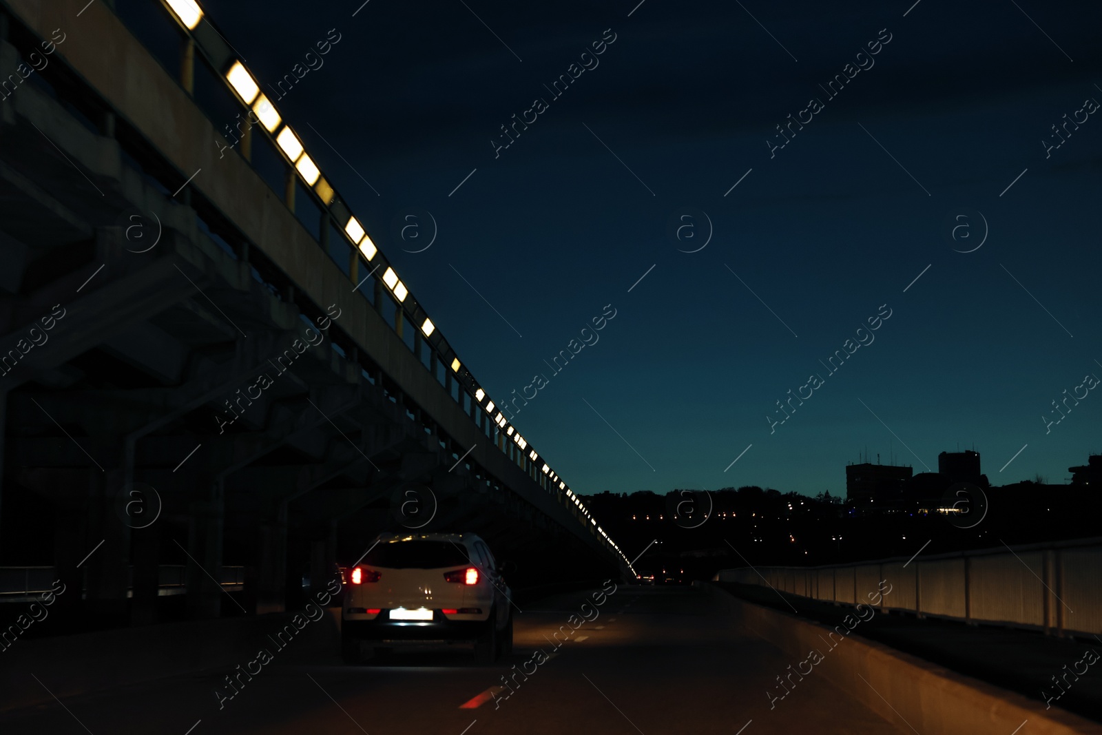 Photo of Cityscape with road traffic and street lights in evening