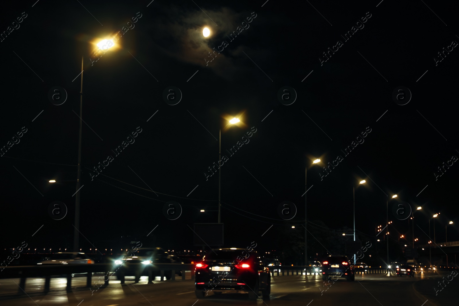 Photo of Cityscape with road traffic and street lights at night