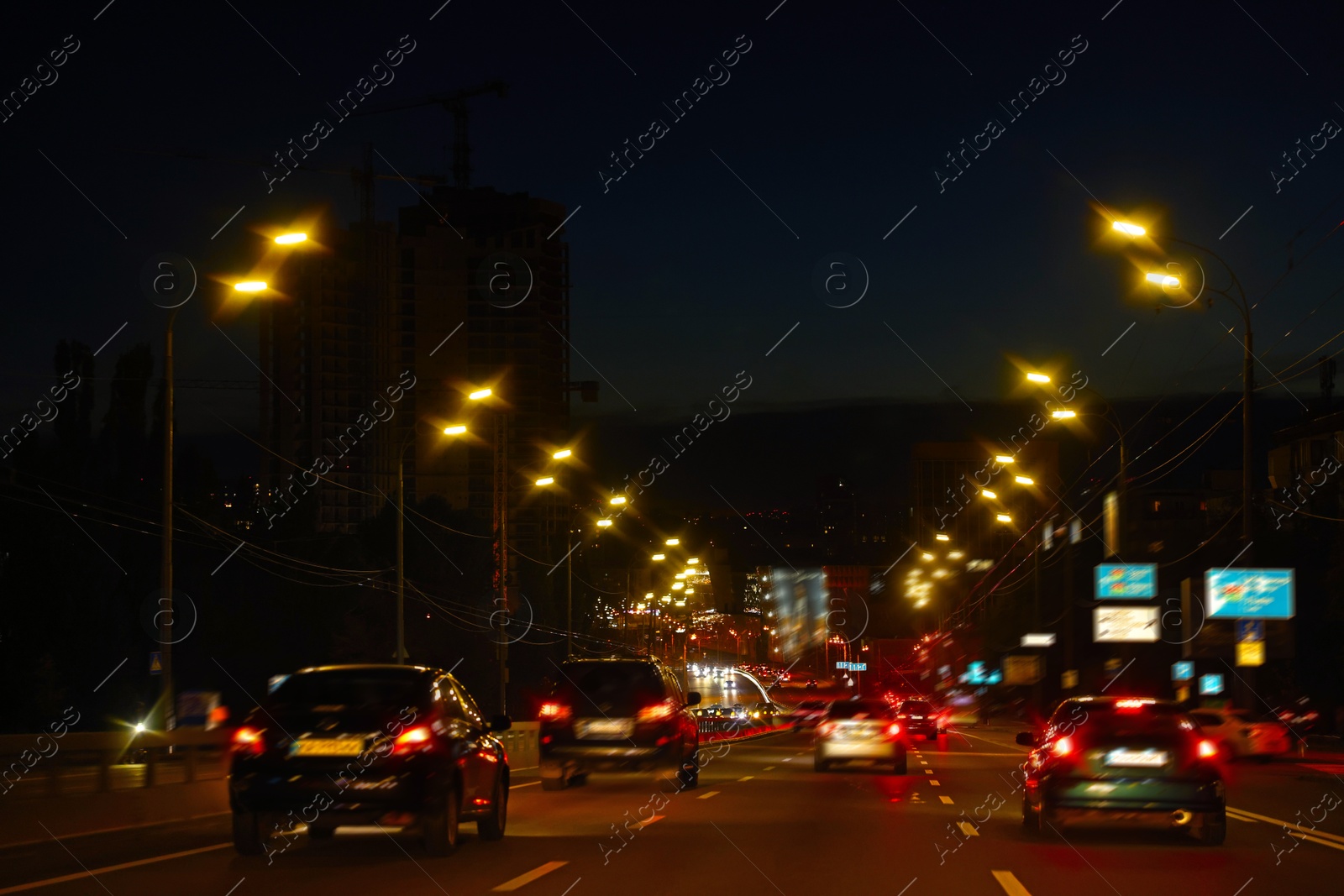 Photo of Cityscape with road traffic and street lights in evening