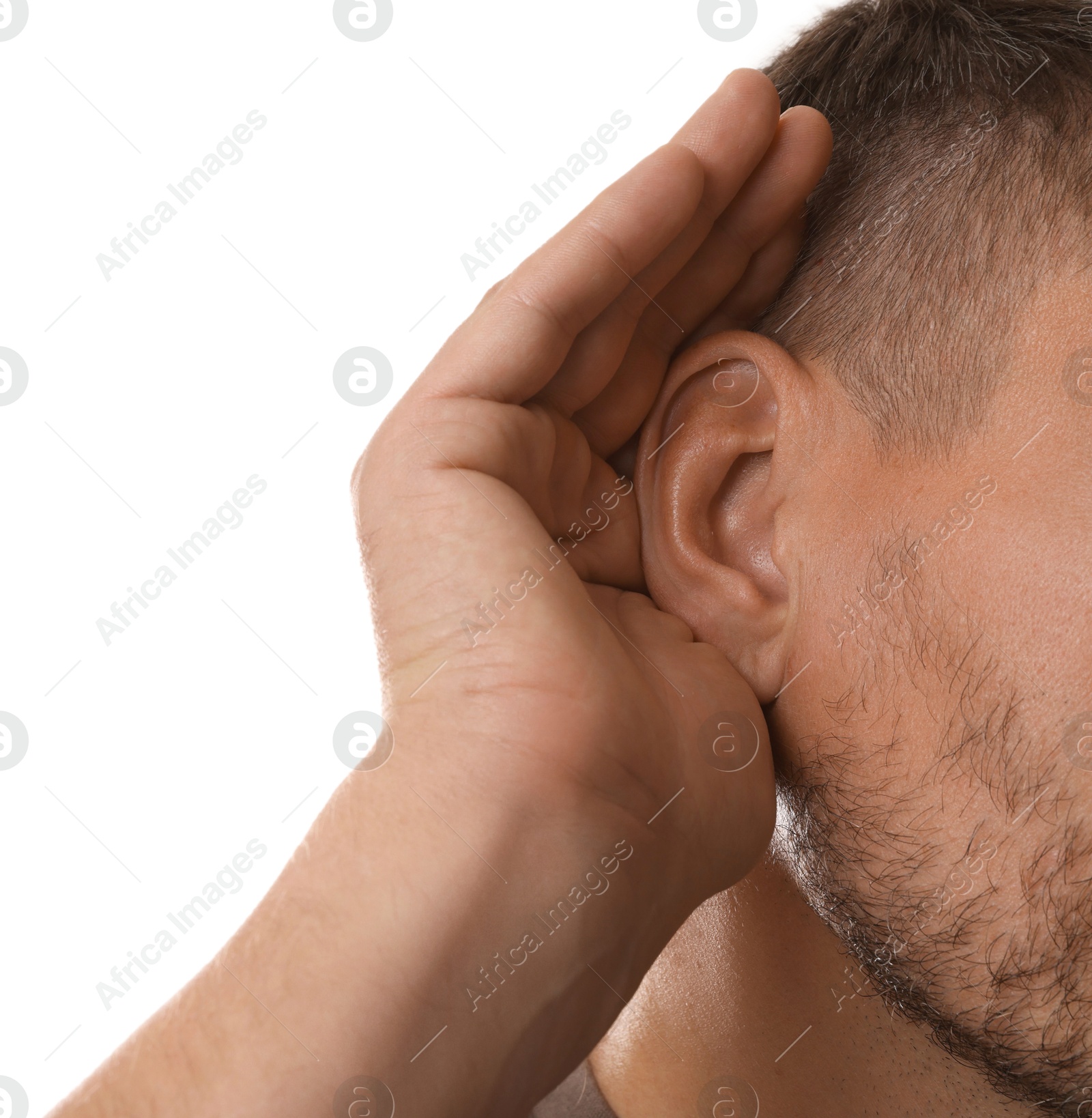 Photo of Man showing hand to ear gesture on white background, closeup