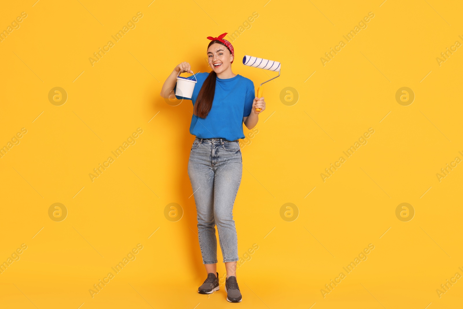 Photo of Full length portrait of young decorator on orange background