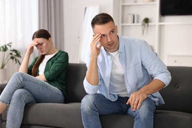 Offended couple ignoring each other at home, selective focus