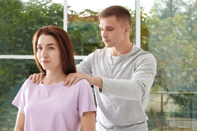 Photo of Osteopath working with patient in clinic. Manual therapy