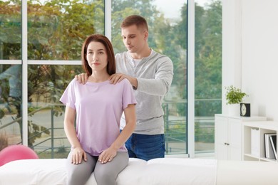 Photo of Osteopath working with patient in clinic. Manual therapy