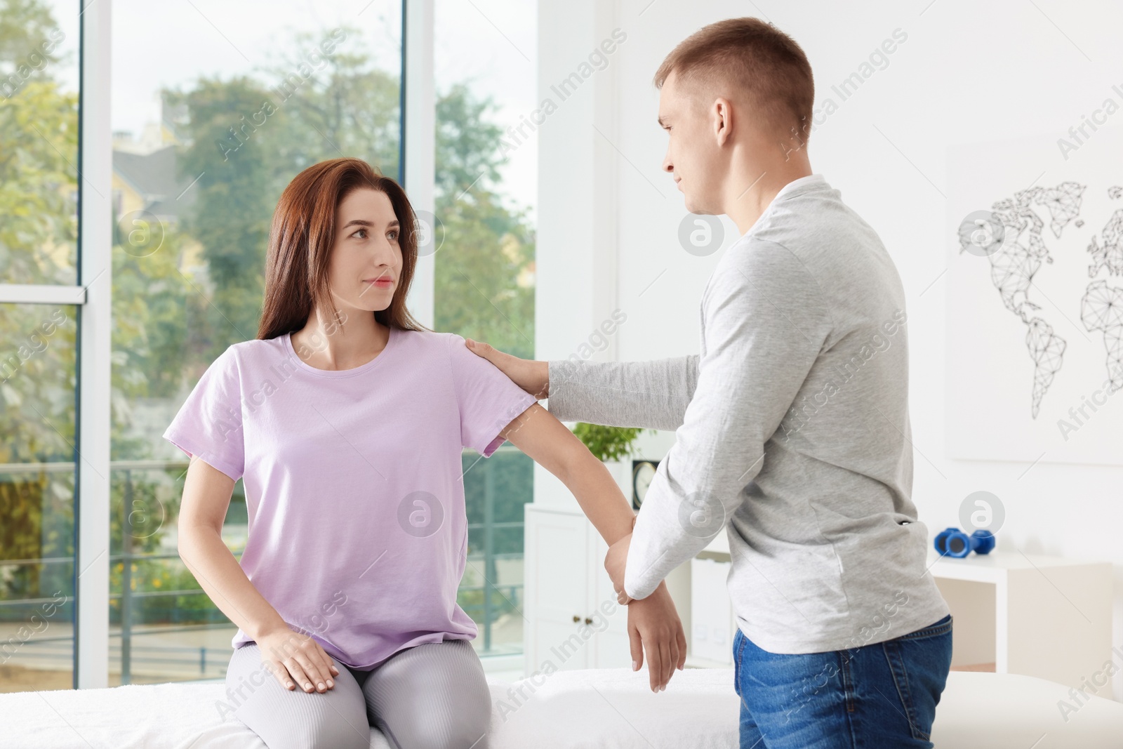 Photo of Osteopath working with patient in clinic. Manual therapy