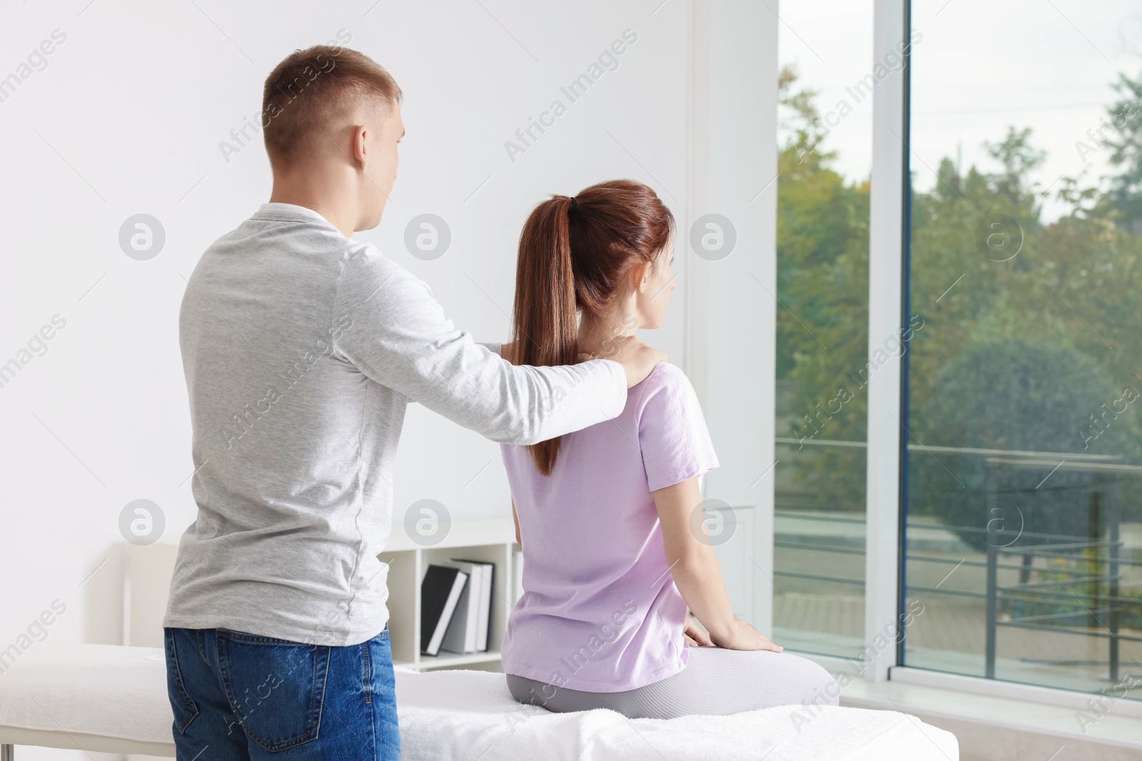 Photo of Osteopath working with patient in clinic. Manual therapy