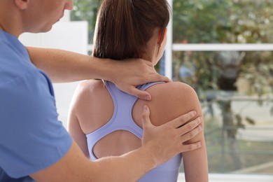 Photo of Osteopath working with patient in clinic, closeup. Manual therapy