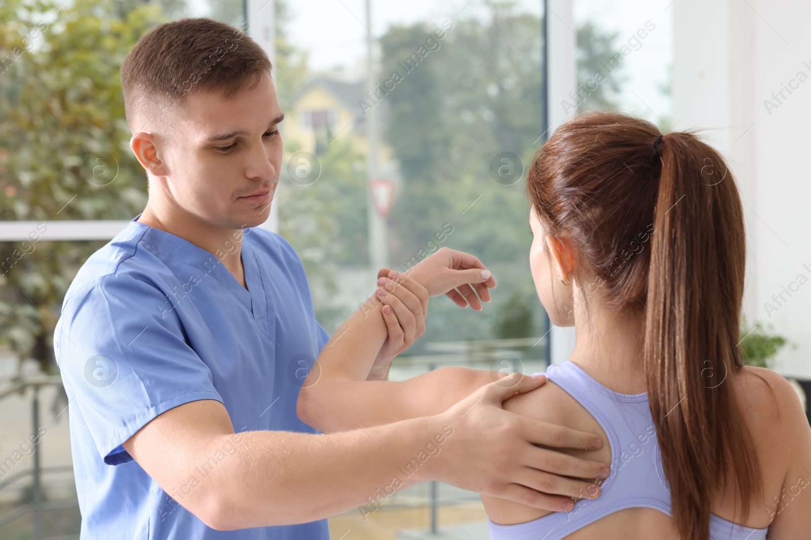 Photo of Osteopath working with patient in clinic. Manual therapy