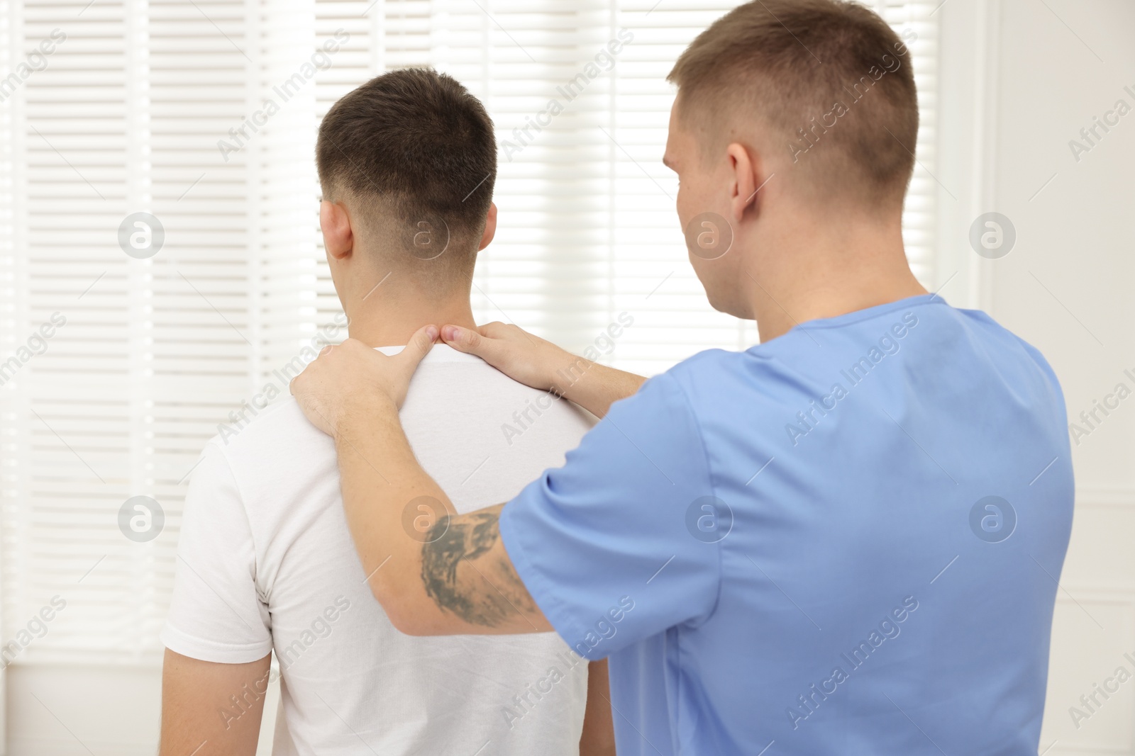 Photo of Osteopath working with patient in clinic. Manual therapy