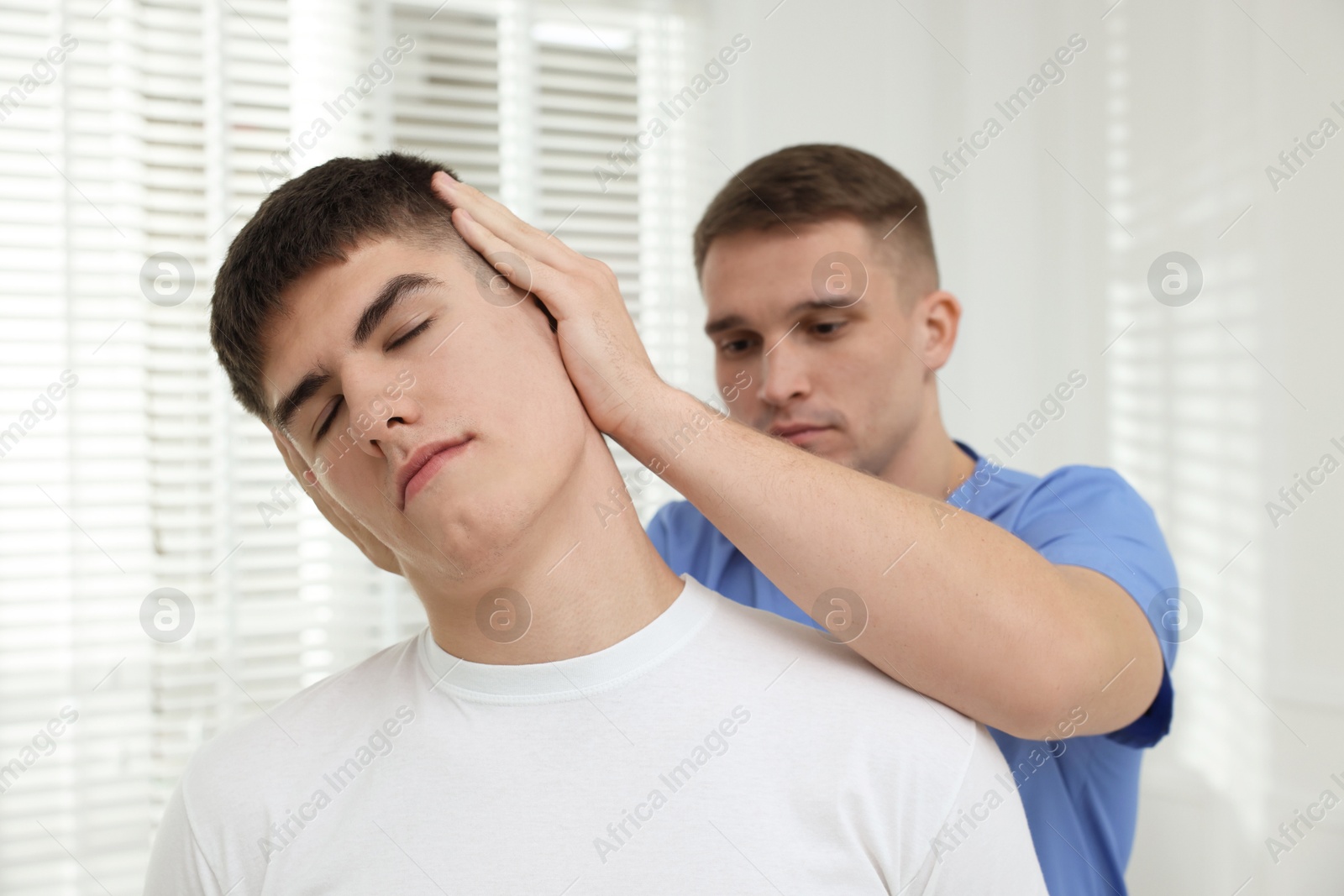 Photo of Osteopath working with patient in clinic. Manual therapy