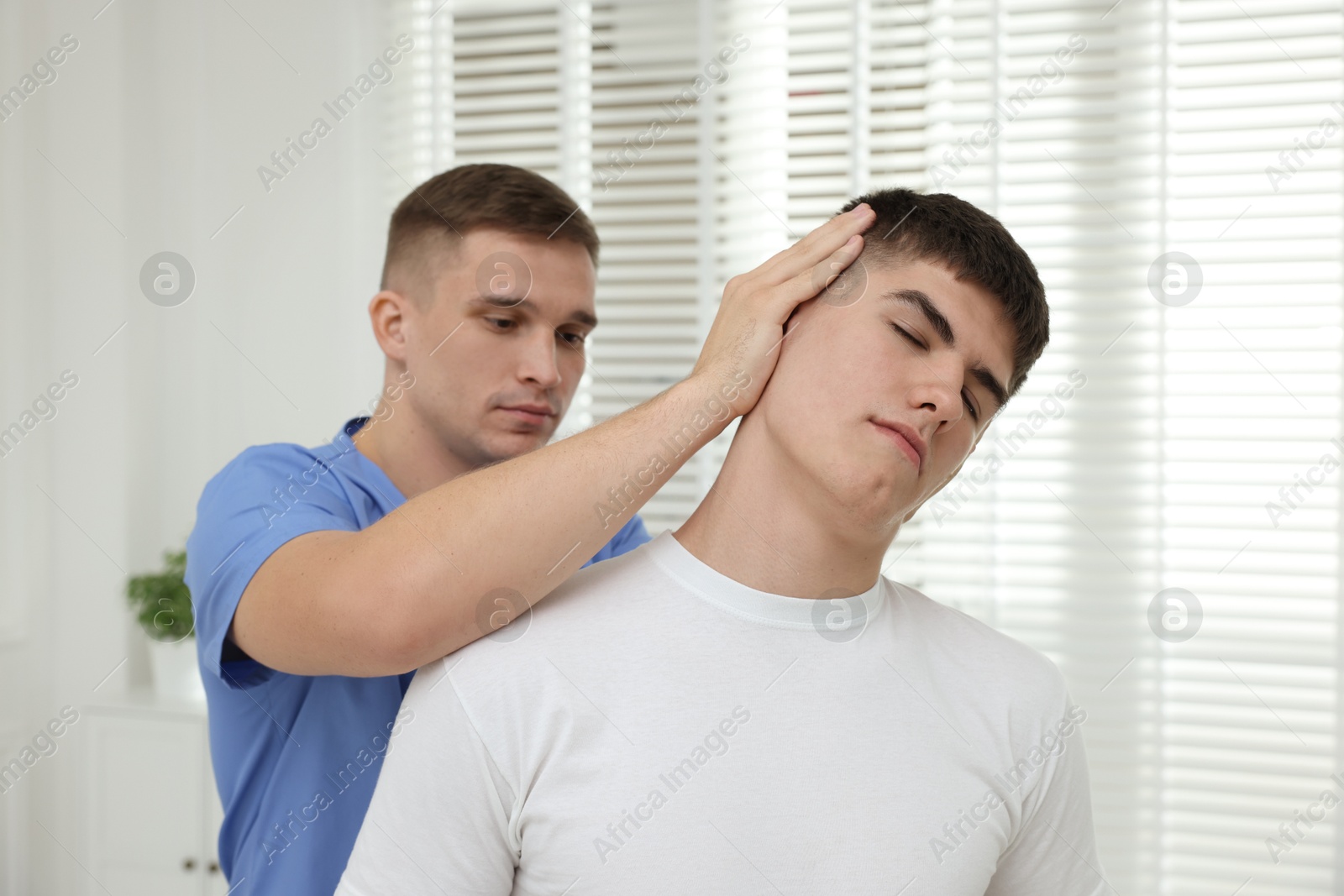 Photo of Osteopath working with patient in clinic. Manual therapy