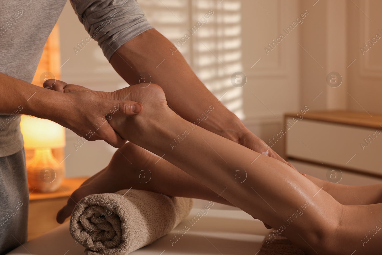 Photo of Osteopath working with patient indoors, closeup. Manual therapy