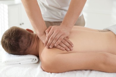 Photo of Massage therapist working with patient in clinic, closeup