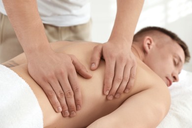 Photo of Massage therapist working with patient in clinic, closeup