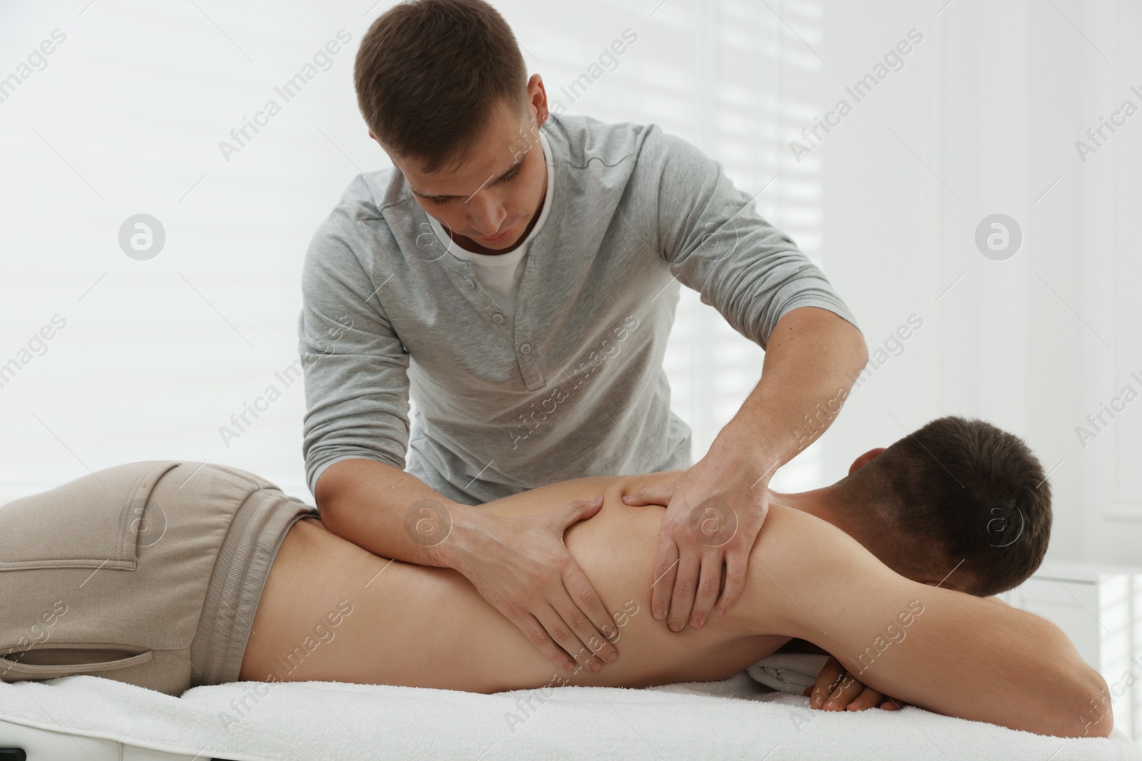 Photo of Massage therapist working with patient in clinic