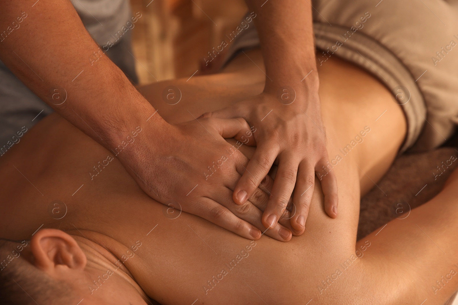 Photo of Massage therapist working with patient in clinic, closeup