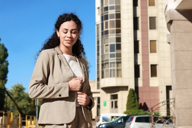 Photo of Portrait of young woman wearing stylish suit outdoors