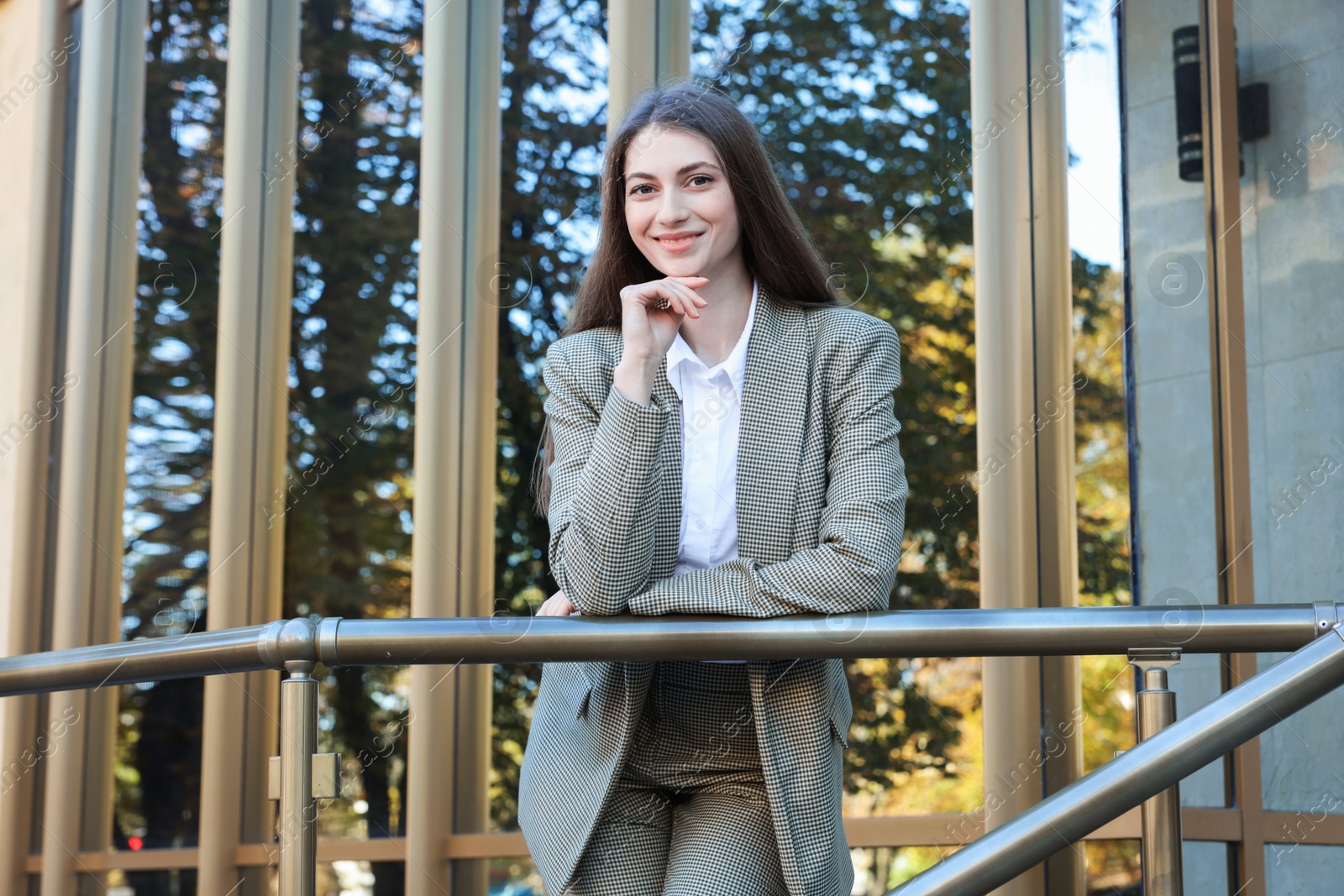 Photo of Portrait of young woman wearing stylish suit outdoors