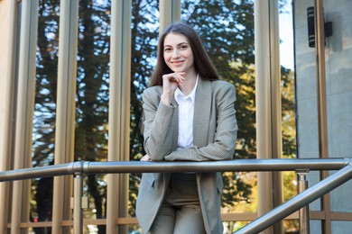 Photo of Portrait of young woman wearing stylish suit outdoors