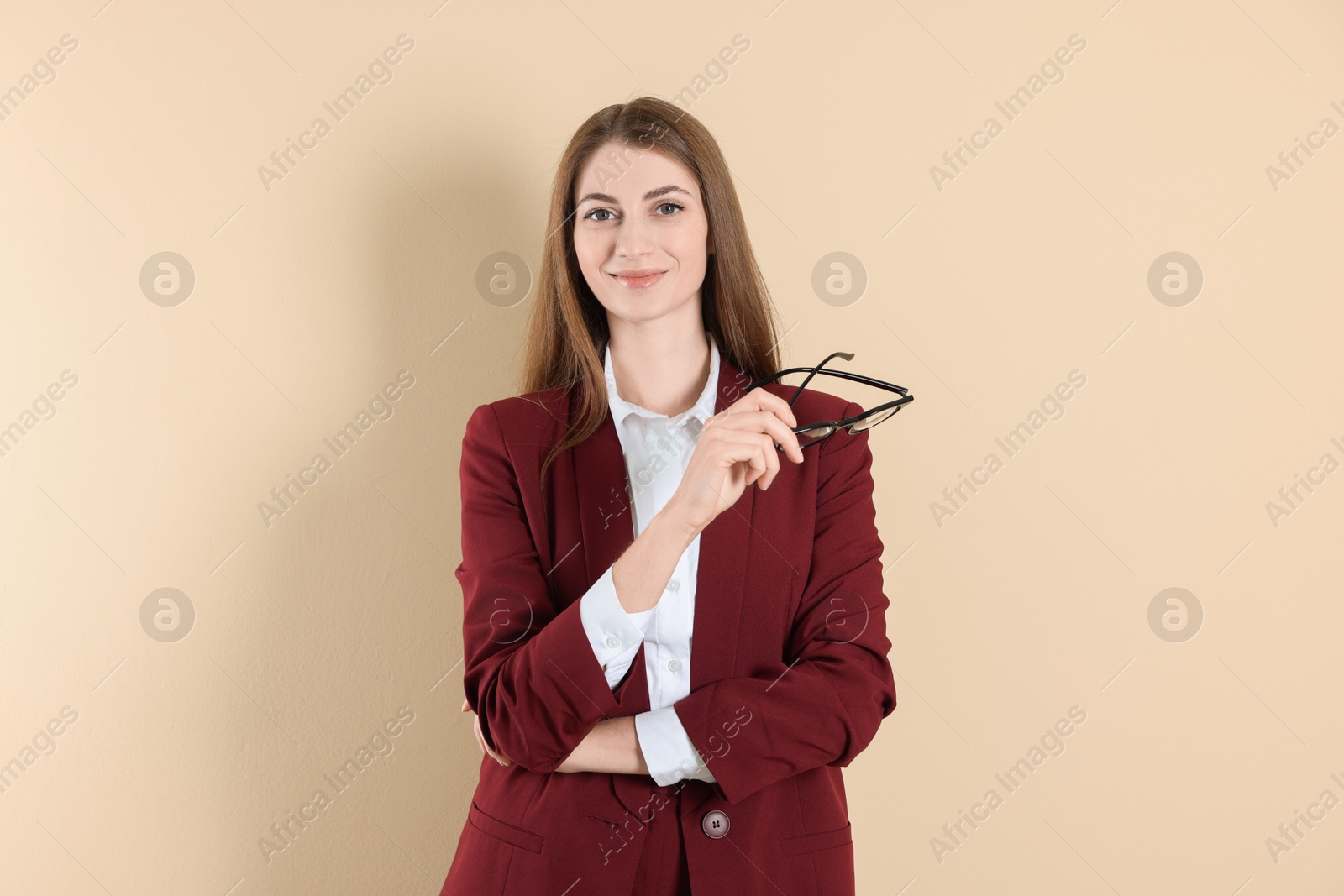 Photo of Portrait of smiling banker on beige background