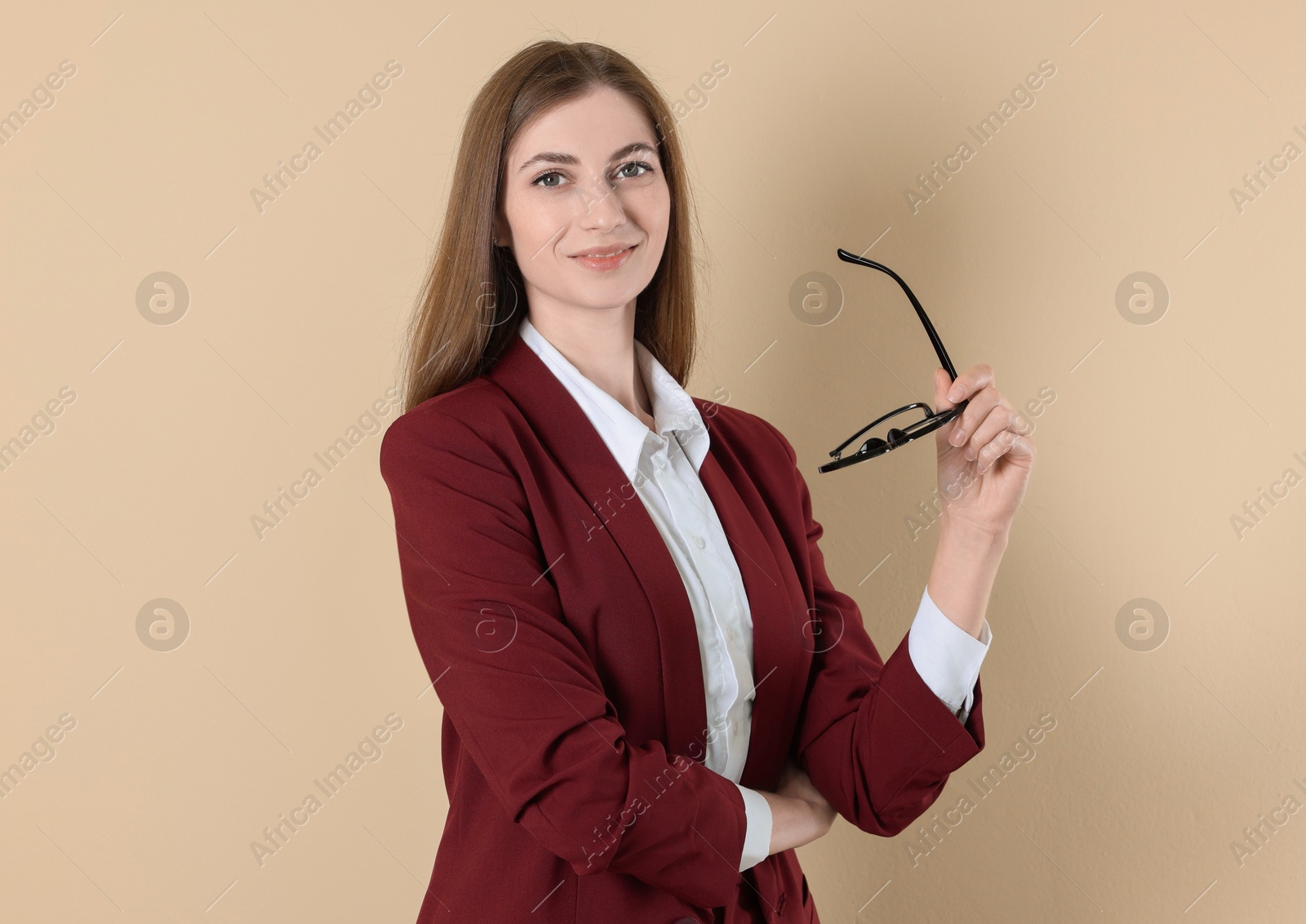 Photo of Portrait of smiling banker on beige background