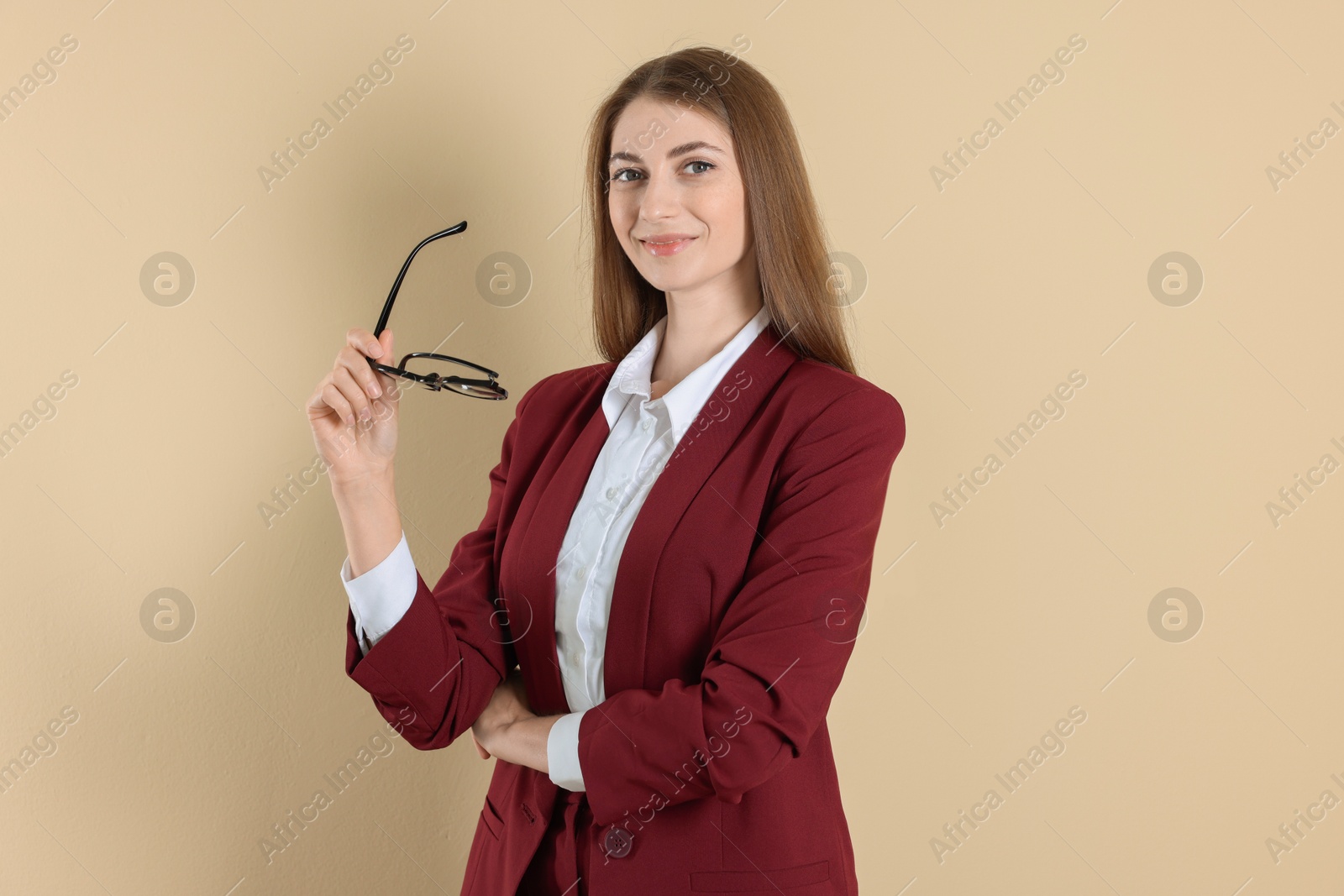 Photo of Portrait of smiling banker on beige background