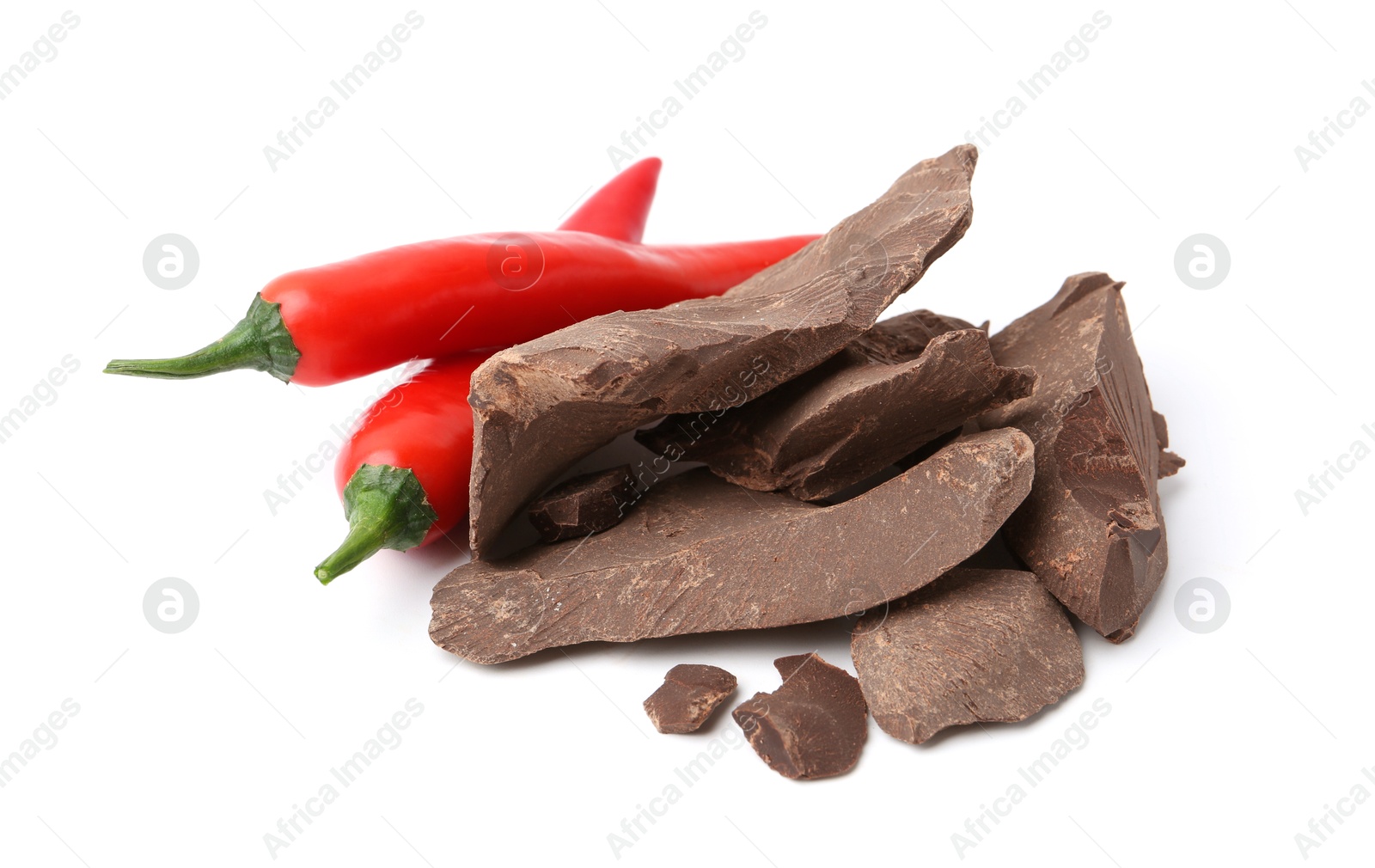 Photo of Pieces of tasty chocolate with chili peppers isolated on white