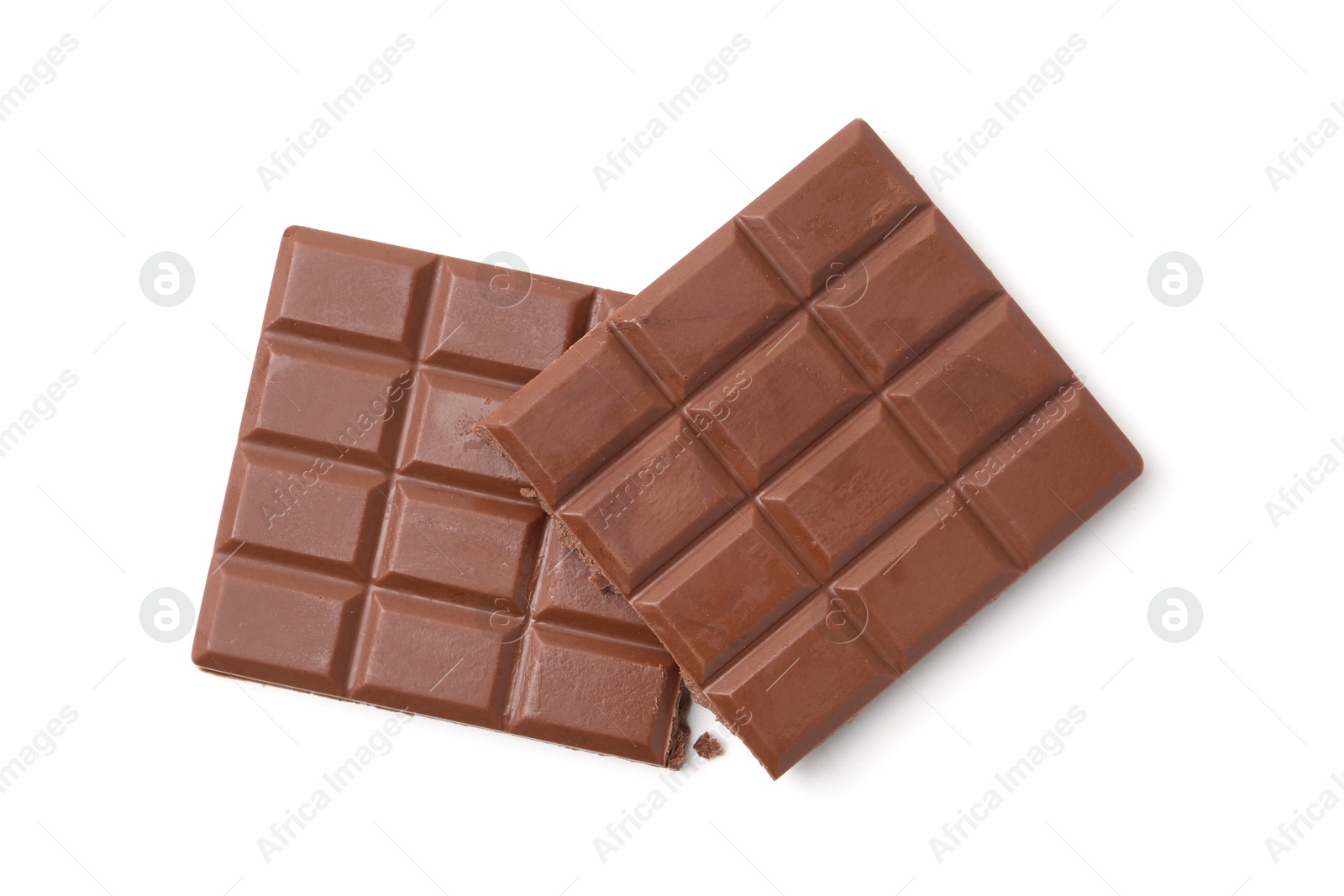 Photo of Pieces of delicious milk chocolate isolated on white, top view