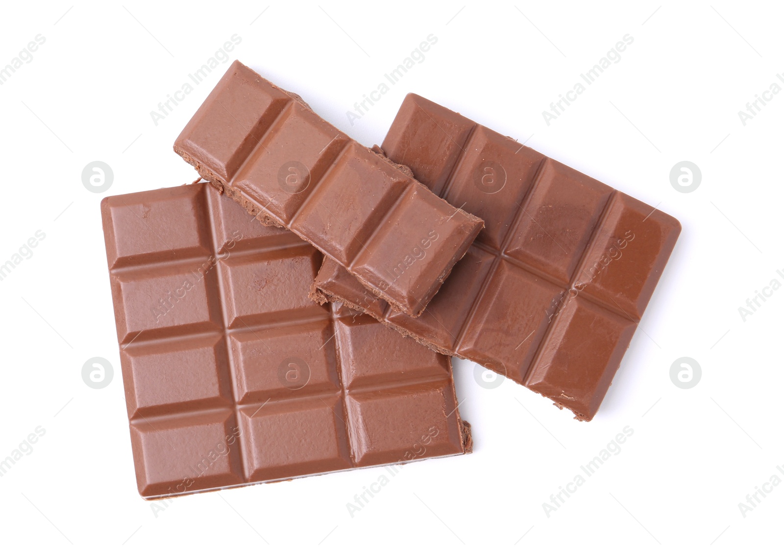 Photo of Pieces of delicious milk chocolate isolated on white, top view