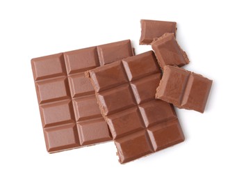 Photo of Pieces of delicious milk chocolate isolated on white, top view